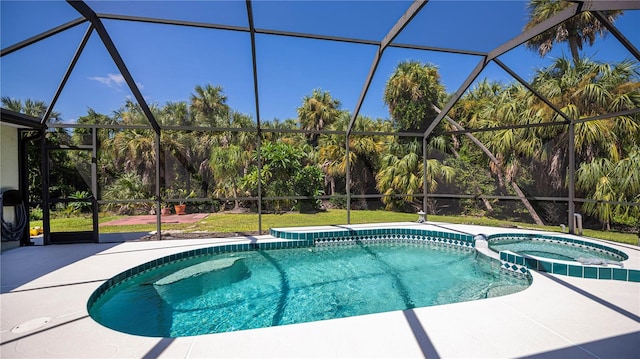 view of swimming pool with a patio, glass enclosure, and an in ground hot tub