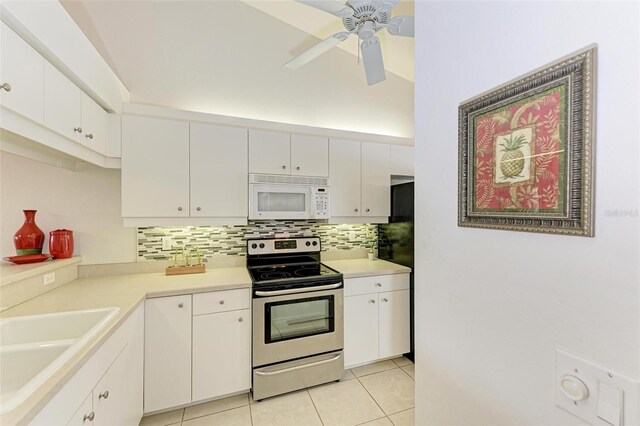 kitchen featuring stainless steel electric stove, white cabinets, tasteful backsplash, light tile patterned flooring, and sink