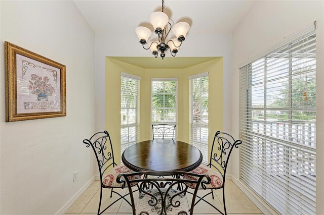 tiled dining room featuring a chandelier