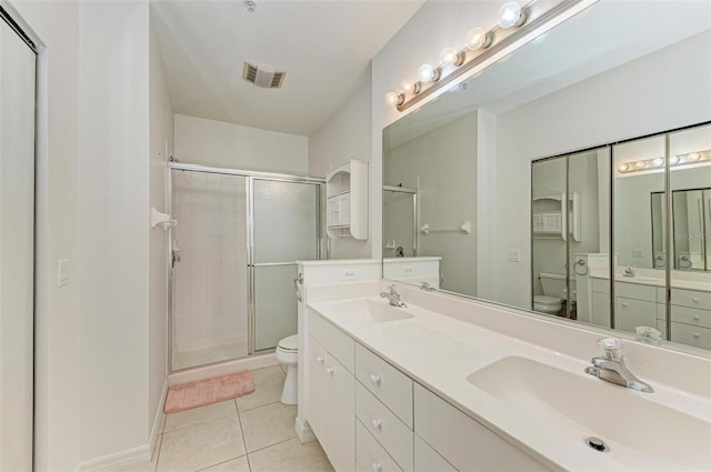 bathroom featuring toilet, a stall shower, and a sink