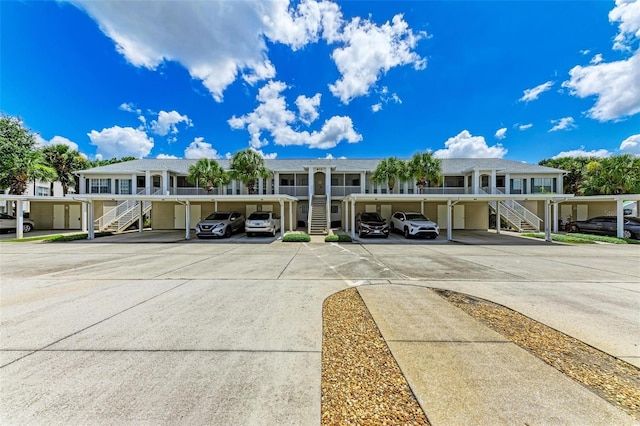 view of front of house featuring covered parking and stairway