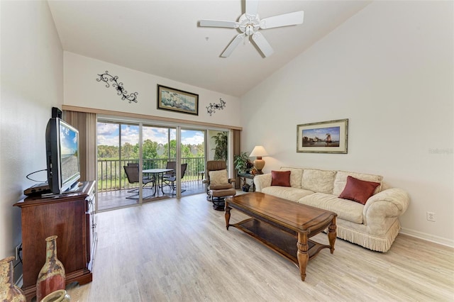 living room featuring light wood-type flooring, ceiling fan, high vaulted ceiling, and baseboards