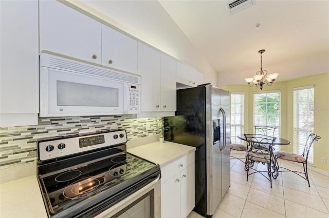 kitchen featuring stainless steel appliances, lofted ceiling, pendant lighting, and white cabinets