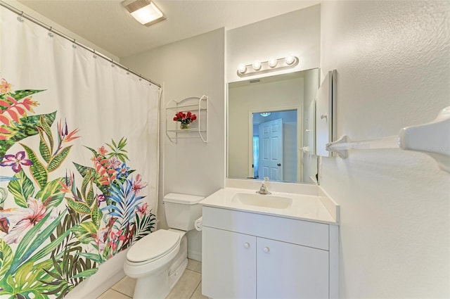 bathroom featuring tile patterned flooring, a shower with shower curtain, vanity, and toilet