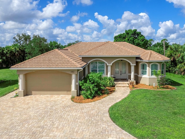 mediterranean / spanish-style house with a front lawn and a garage