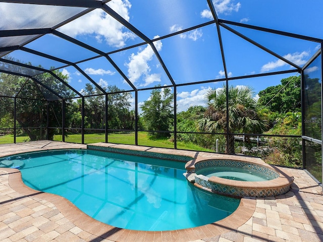 view of pool with glass enclosure and an in ground hot tub