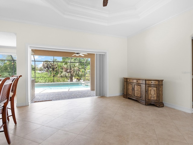 interior space featuring a tray ceiling, ceiling fan, and a wealth of natural light