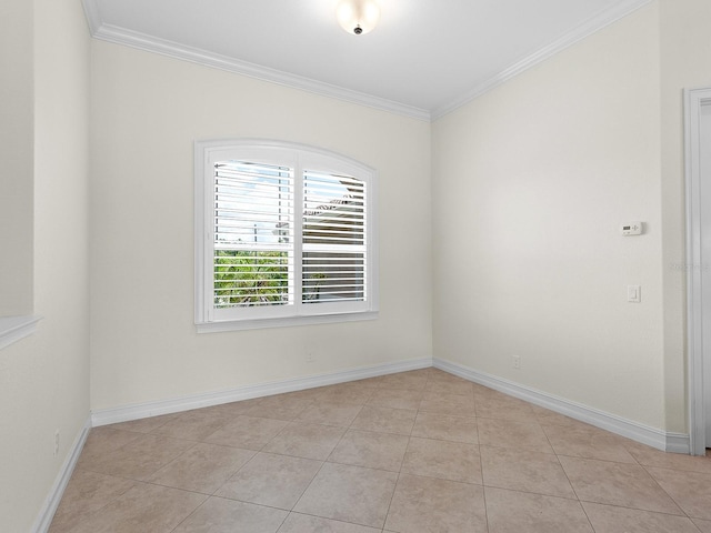 tiled spare room with crown molding