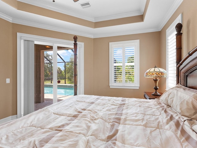 bedroom featuring a tray ceiling, ornamental molding, and access to exterior