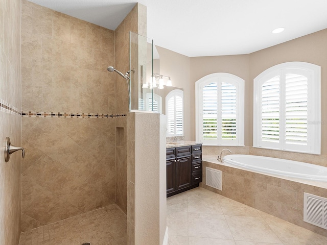 bathroom featuring tile patterned flooring, vanity, and plus walk in shower