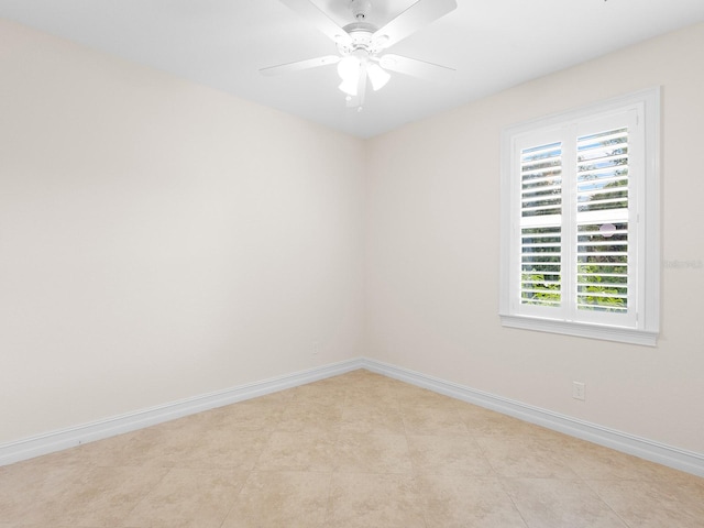 tiled spare room with ceiling fan