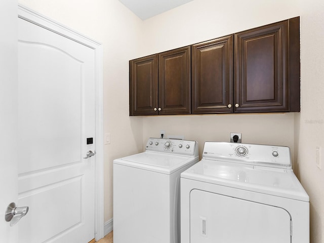 washroom featuring cabinets and washer and dryer