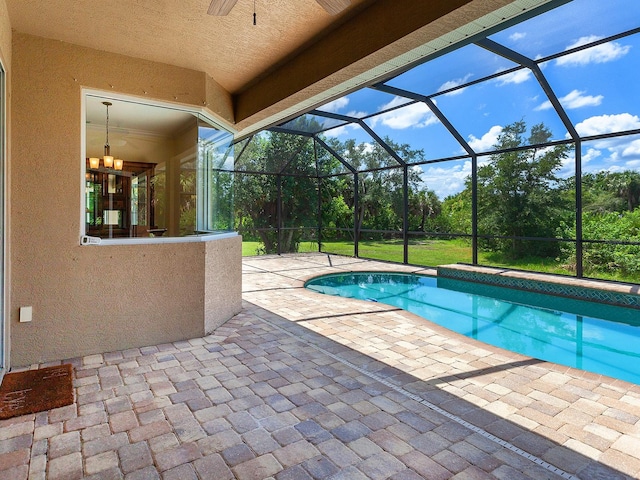 view of pool with a lanai, ceiling fan, and a patio