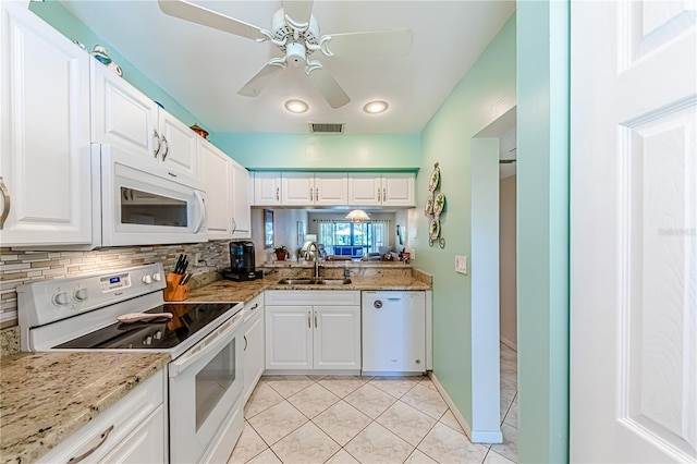 kitchen with ceiling fan, sink, white appliances, and white cabinetry