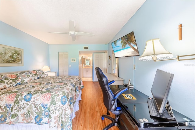 bedroom featuring a closet, a textured ceiling, ceiling fan, and light hardwood / wood-style floors