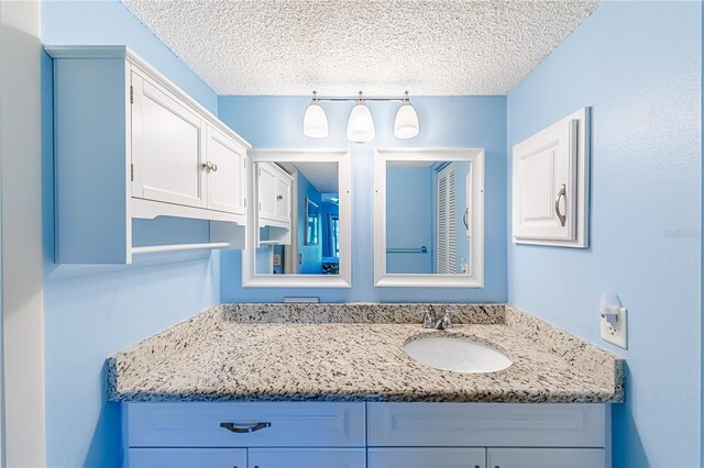 bathroom with vanity and a textured ceiling