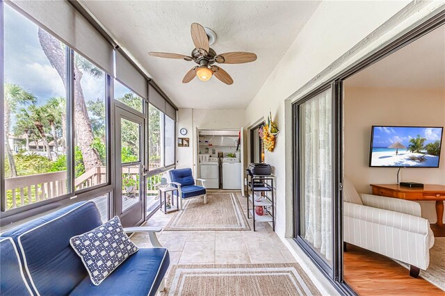 sunroom / solarium with ceiling fan and independent washer and dryer