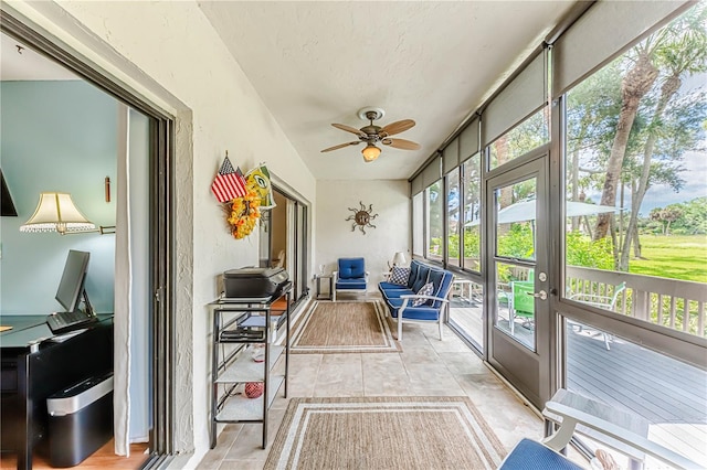 sunroom featuring ceiling fan