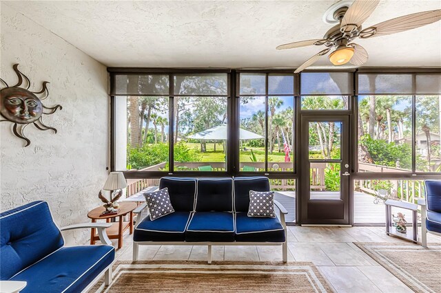 unfurnished sunroom featuring ceiling fan