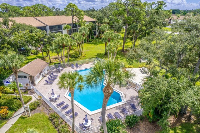 view of pool featuring a lawn and a patio