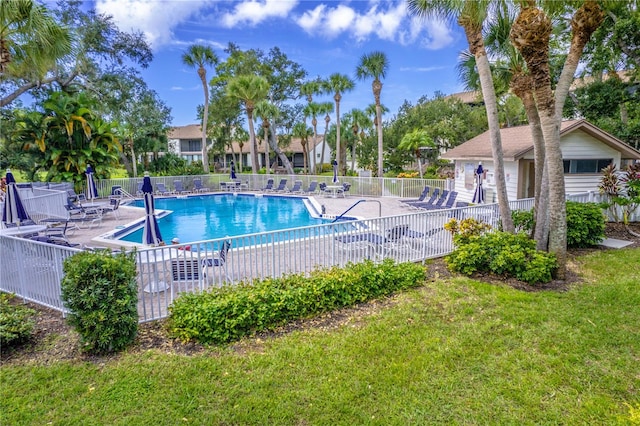 view of swimming pool featuring a lawn and a patio