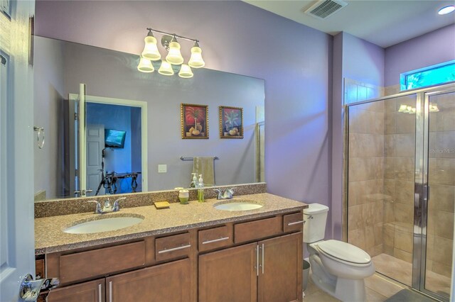 bathroom featuring an enclosed shower, tile patterned flooring, toilet, and vanity