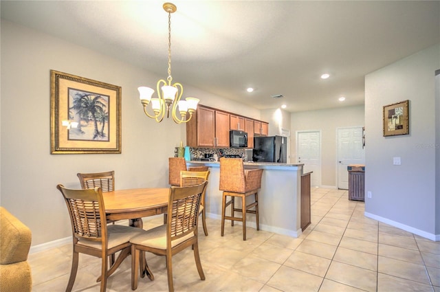 dining area featuring recessed lighting, baseboards, a notable chandelier, and light tile patterned flooring