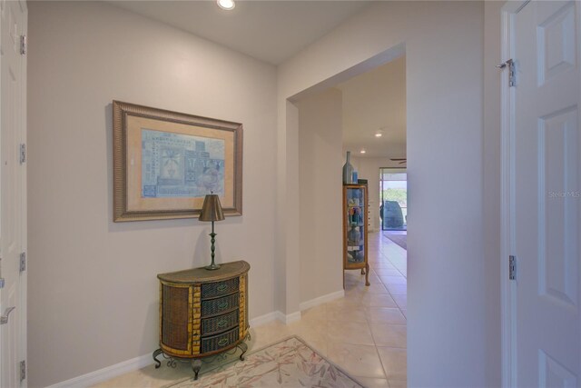 hallway featuring light tile patterned floors, recessed lighting, and baseboards