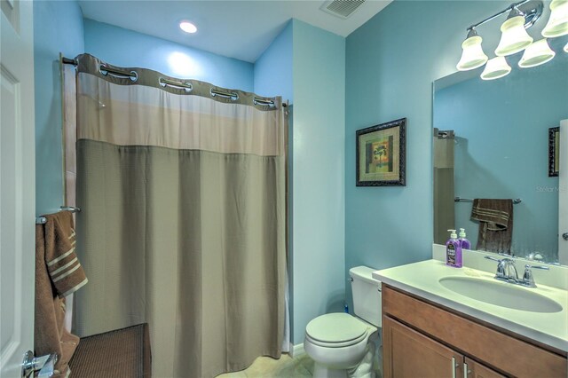 bathroom featuring vanity, a shower with shower curtain, toilet, and visible vents