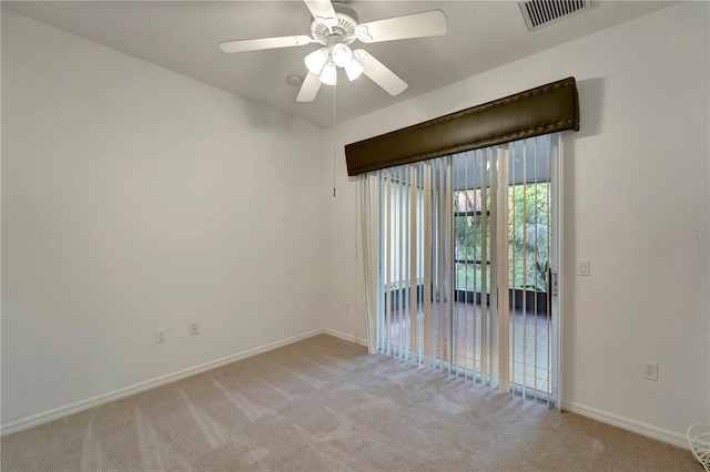 unfurnished room featuring baseboards, ceiling fan, visible vents, and light colored carpet