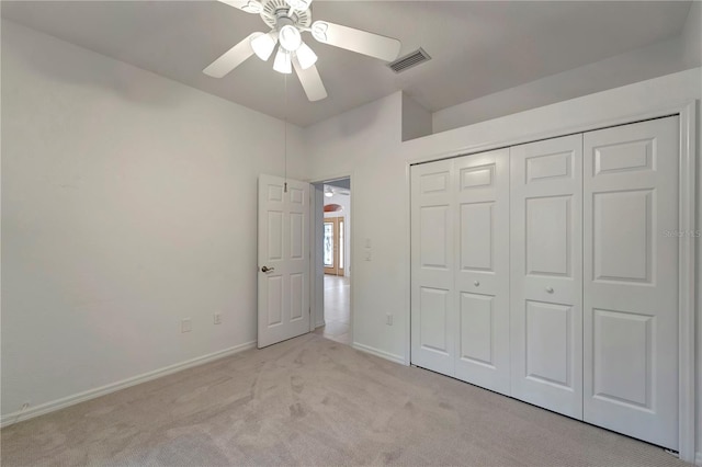 unfurnished bedroom with a closet, visible vents, a ceiling fan, light carpet, and baseboards