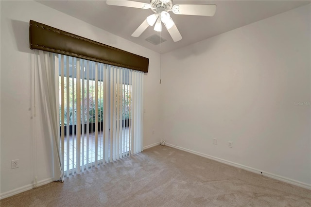 spare room with a ceiling fan, baseboards, visible vents, and carpet flooring