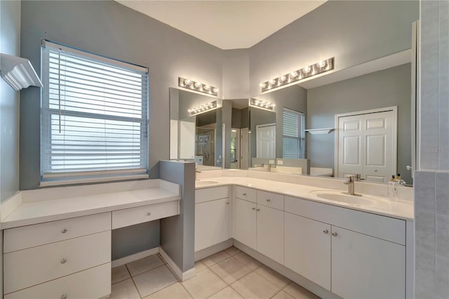 full bathroom featuring double vanity, walk in shower, a sink, and tile patterned floors