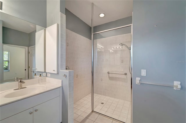 full bath featuring tiled shower and vanity