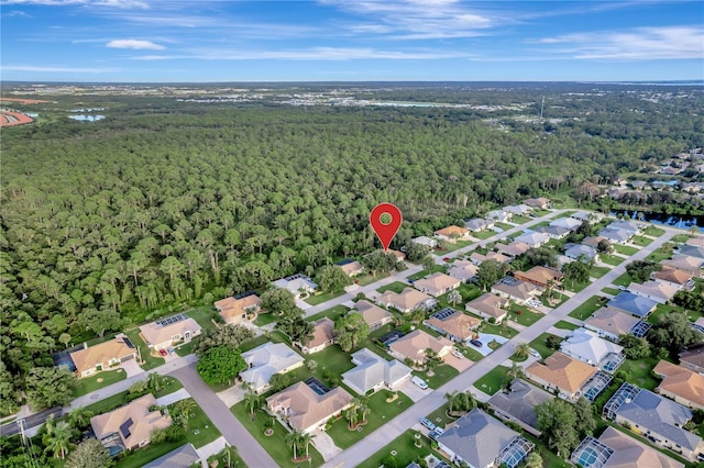 birds eye view of property featuring a forest view and a residential view