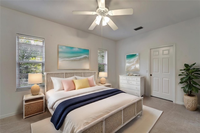 bedroom with visible vents, ceiling fan, light carpet, and baseboards