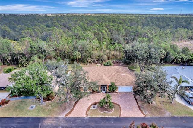 birds eye view of property featuring a forest view