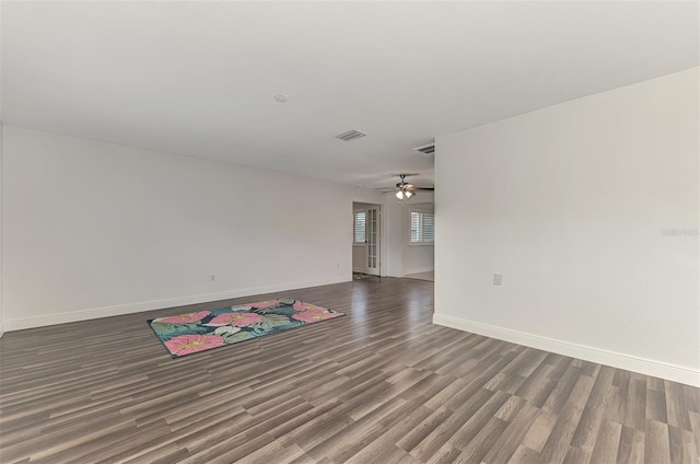 unfurnished room with ceiling fan and dark hardwood / wood-style flooring