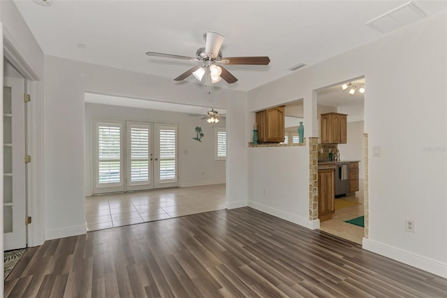 unfurnished living room with french doors, hardwood / wood-style flooring, and ceiling fan