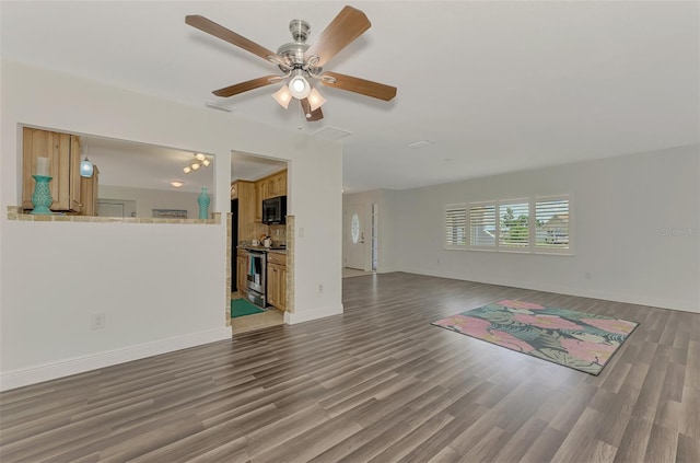 living room with ceiling fan and dark hardwood / wood-style flooring