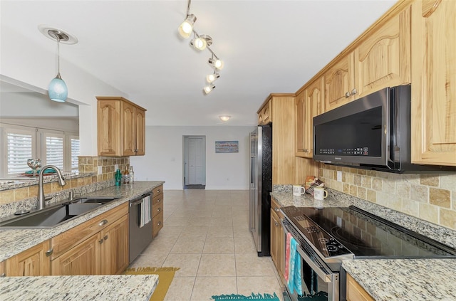 kitchen with appliances with stainless steel finishes, light stone countertops, sink, pendant lighting, and decorative backsplash