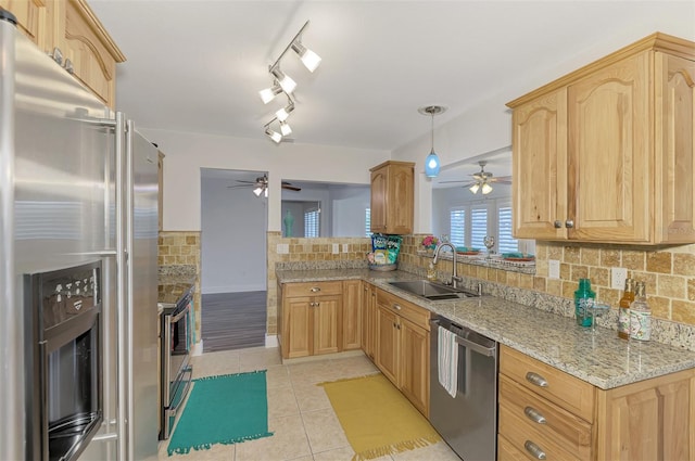 kitchen featuring backsplash, ceiling fan, sink, and stainless steel appliances