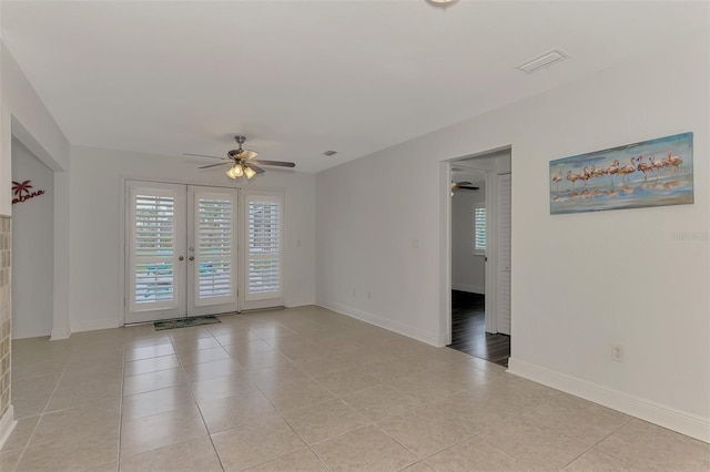 unfurnished room featuring french doors, light tile patterned flooring, and ceiling fan