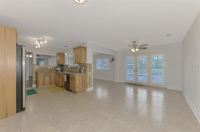 kitchen featuring light brown cabinetry, stainless steel appliances, ceiling fan, and hanging light fixtures