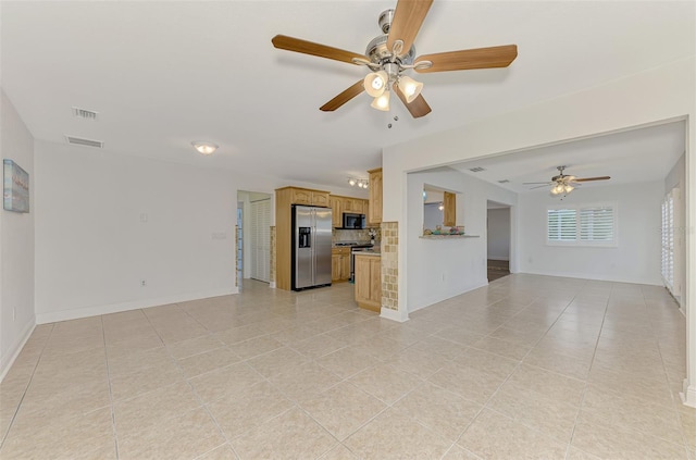 unfurnished living room featuring light tile patterned floors and ceiling fan