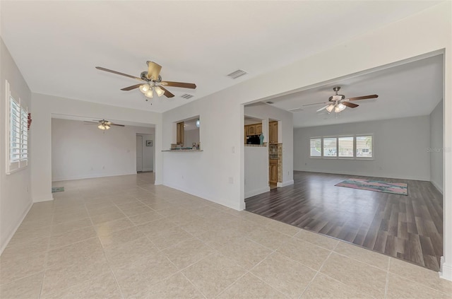 unfurnished room featuring ceiling fan and light hardwood / wood-style floors