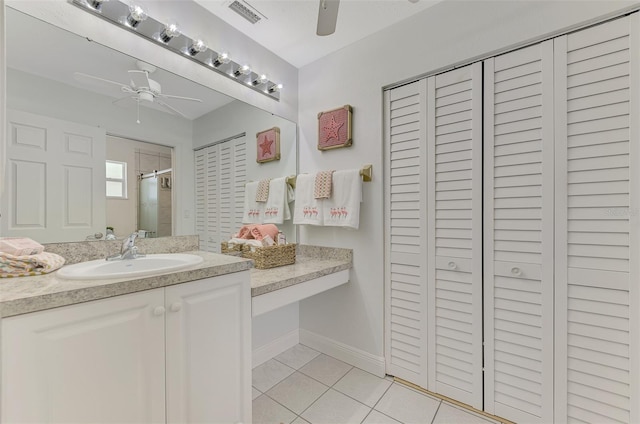 bathroom featuring vanity, walk in shower, ceiling fan, and tile patterned flooring