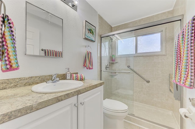 bathroom with vanity, toilet, and an enclosed shower