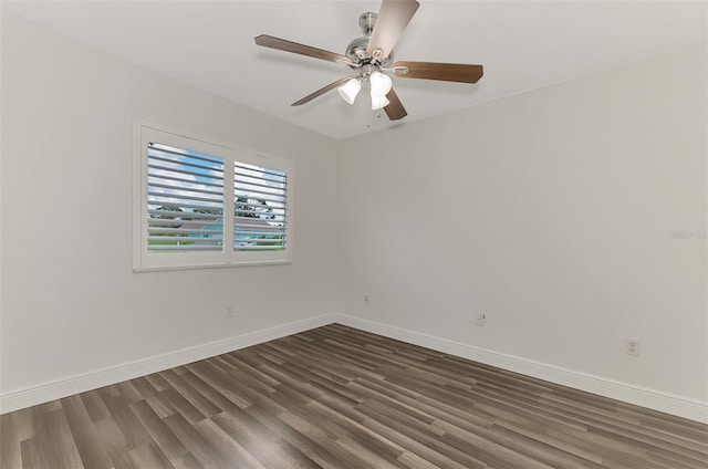 empty room featuring ceiling fan and dark hardwood / wood-style flooring