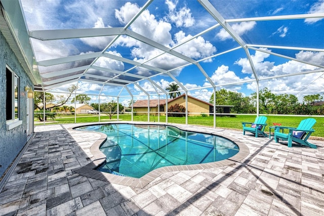 view of swimming pool featuring a yard, a lanai, and a patio area